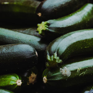 Full frame of zucchinis in a market stall