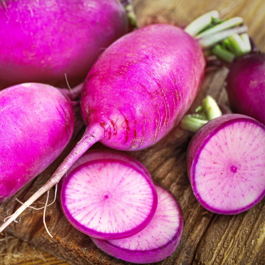 Sliced Radish Red Moon on a wooden surface.